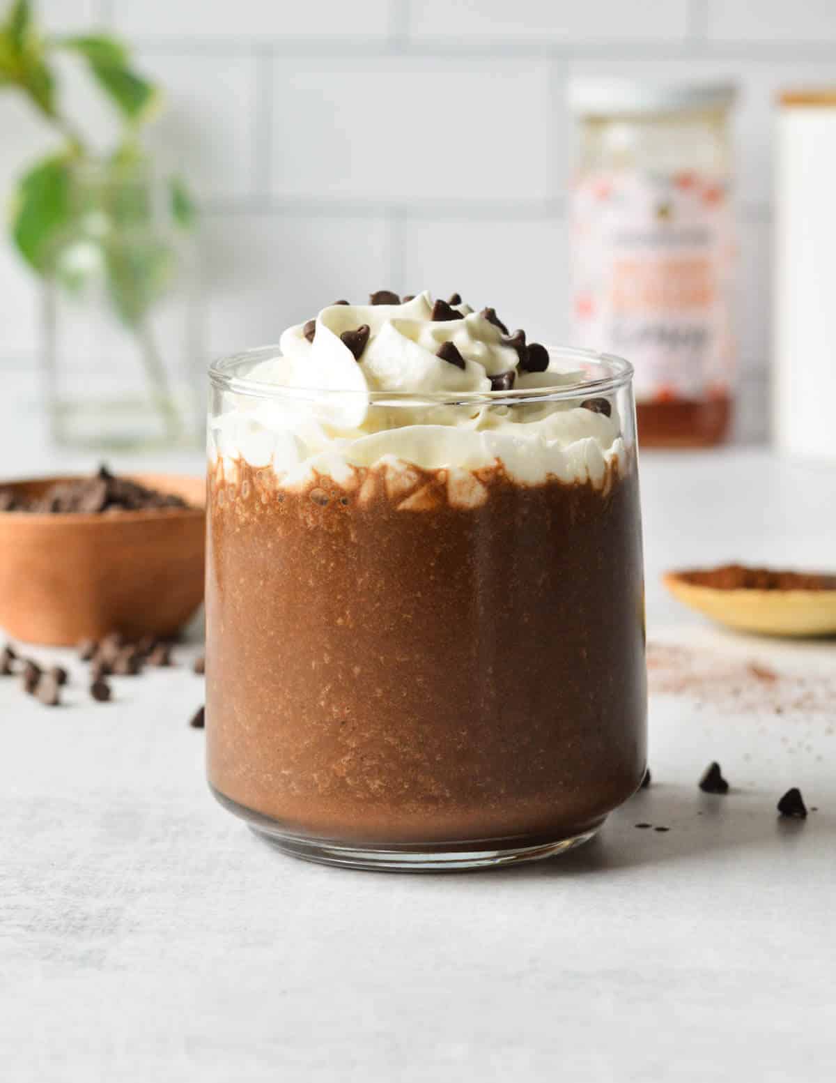 coffee smoothie with whipped cream and chocolate chips on top.