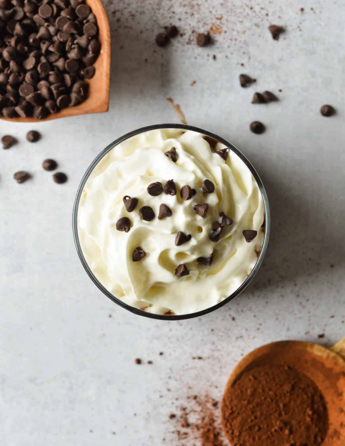 the top of a coffee smoothie with whipped cream and mini chocolate chips on top.