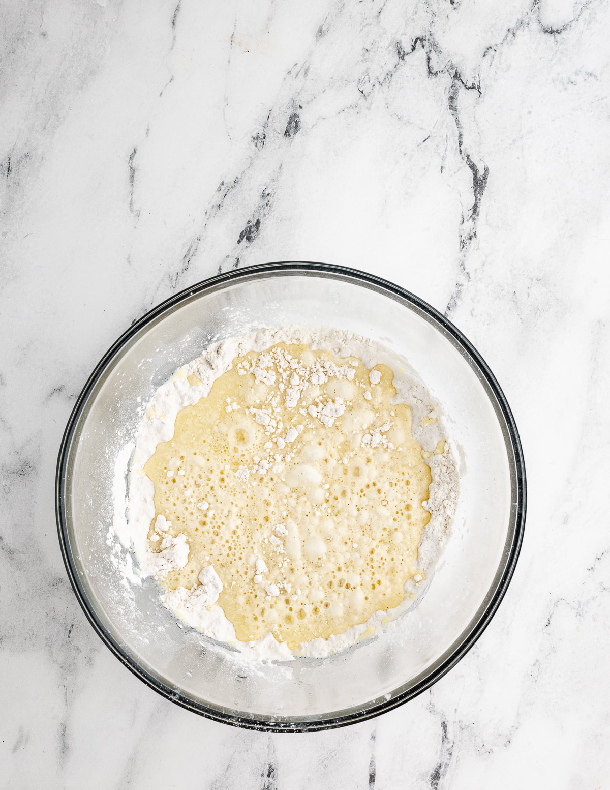 dry ingredients and wet ingredients for gluten free waffles in a bowl.