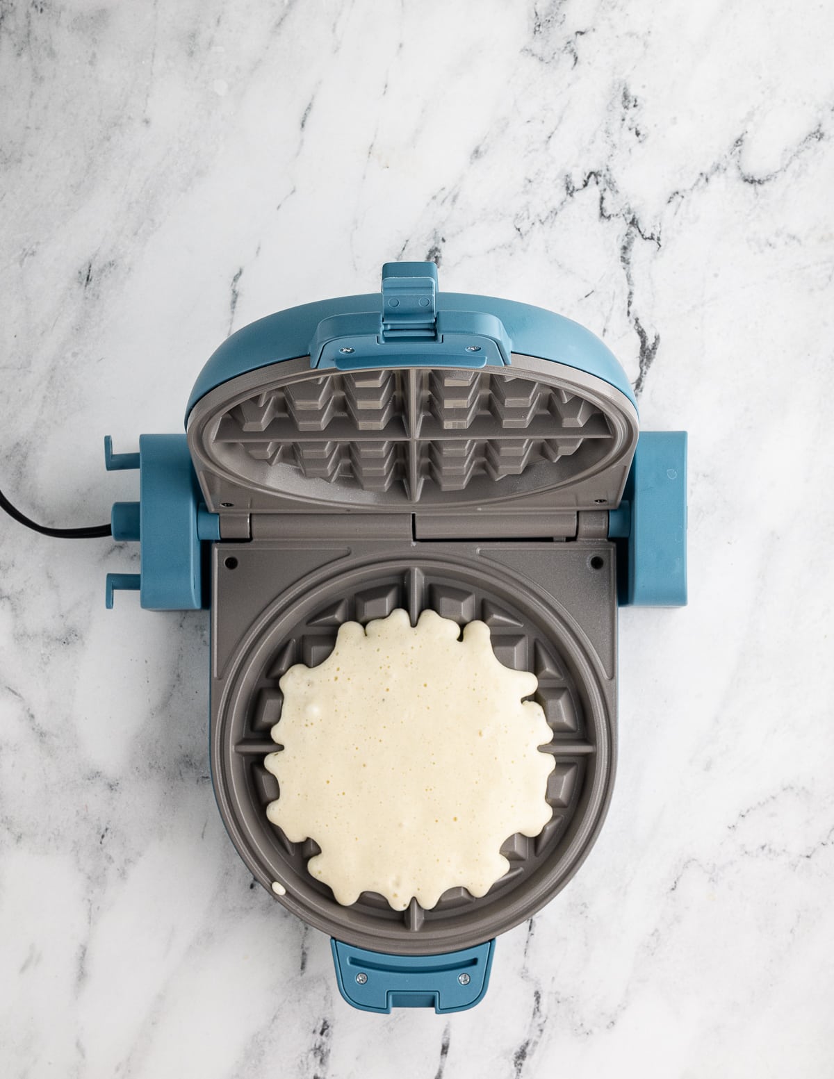 waffle batter in a waffle iron.
