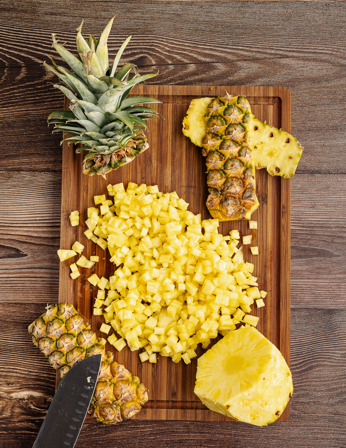 small diced pineapple on a cutting board.