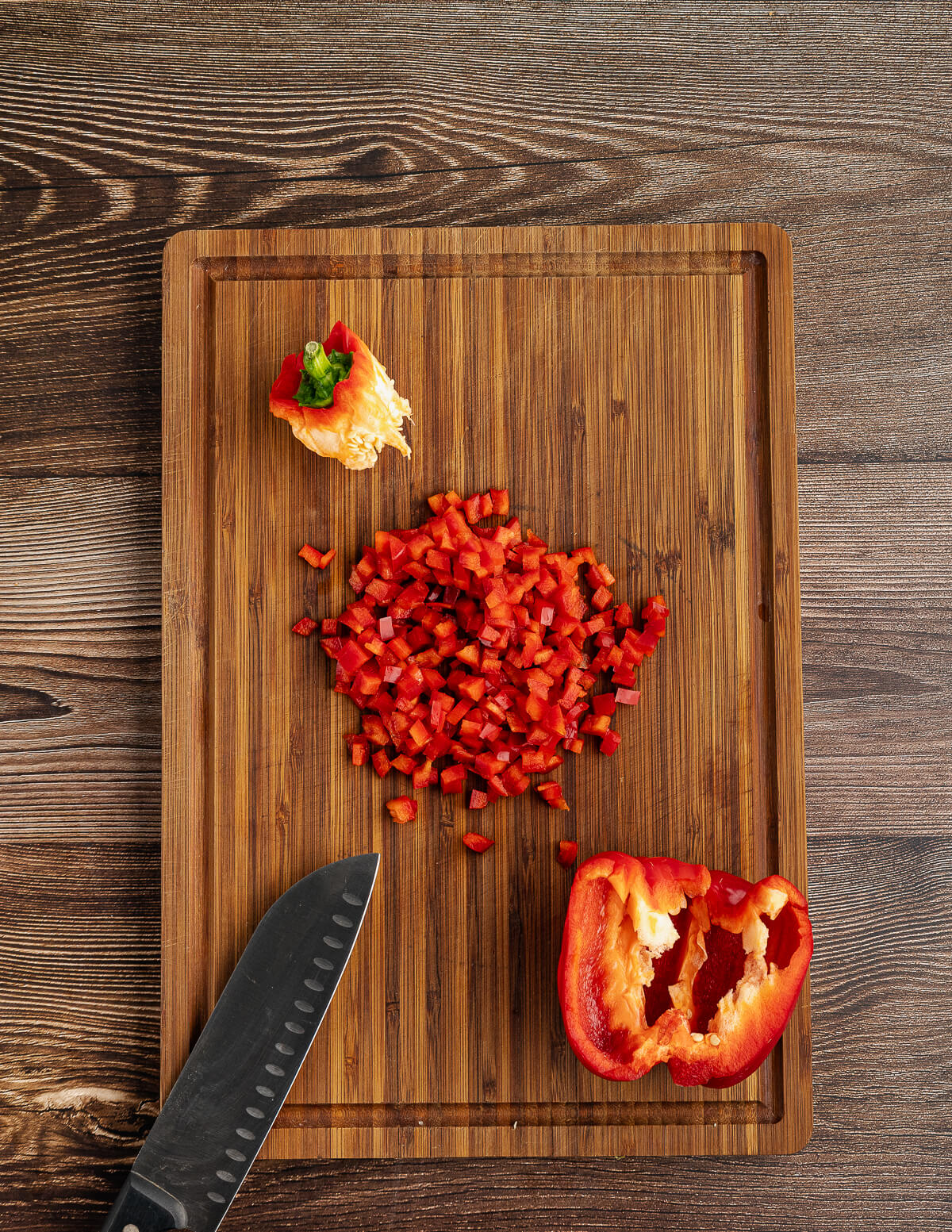 diced red bell pepper on a cutting board.