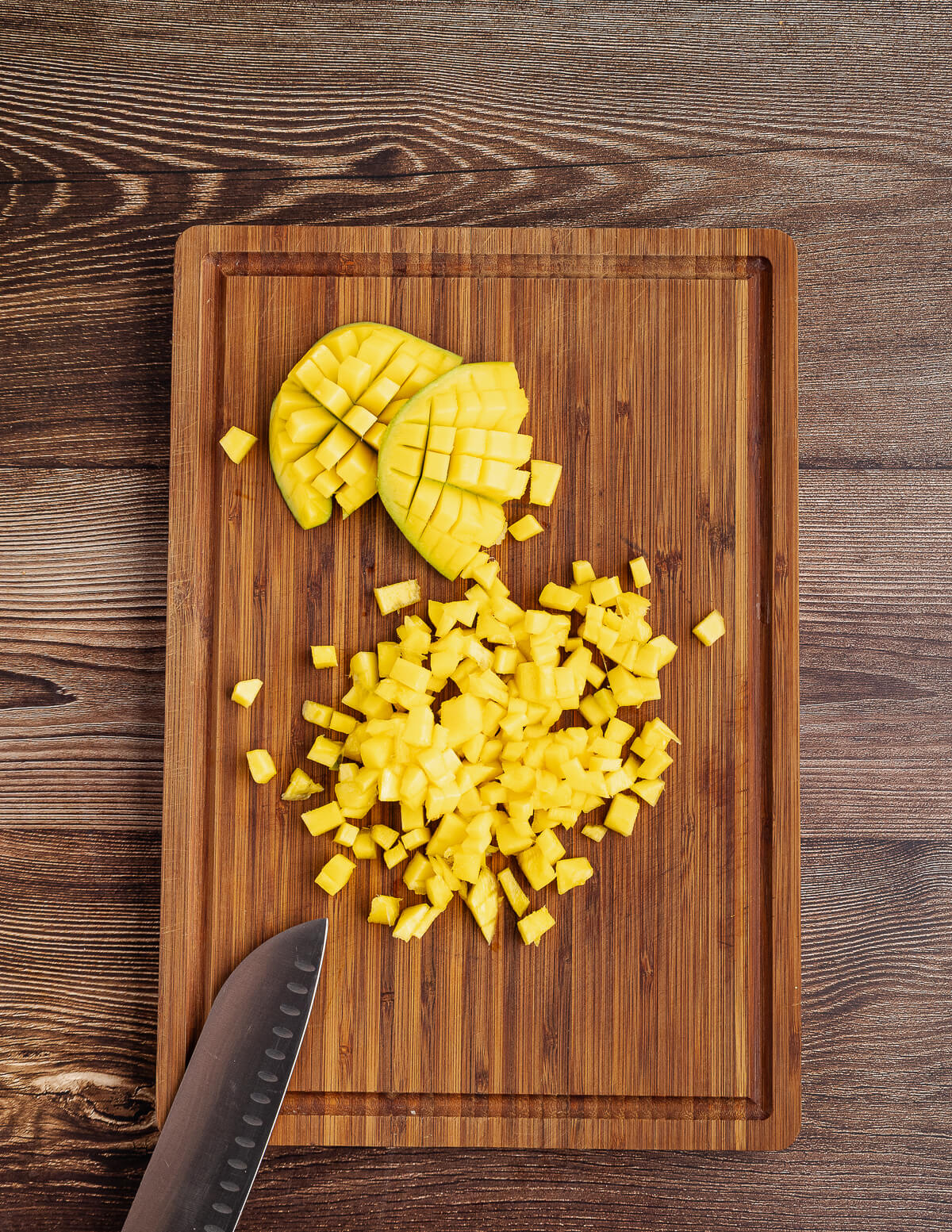 small diced mango on a cutting board.