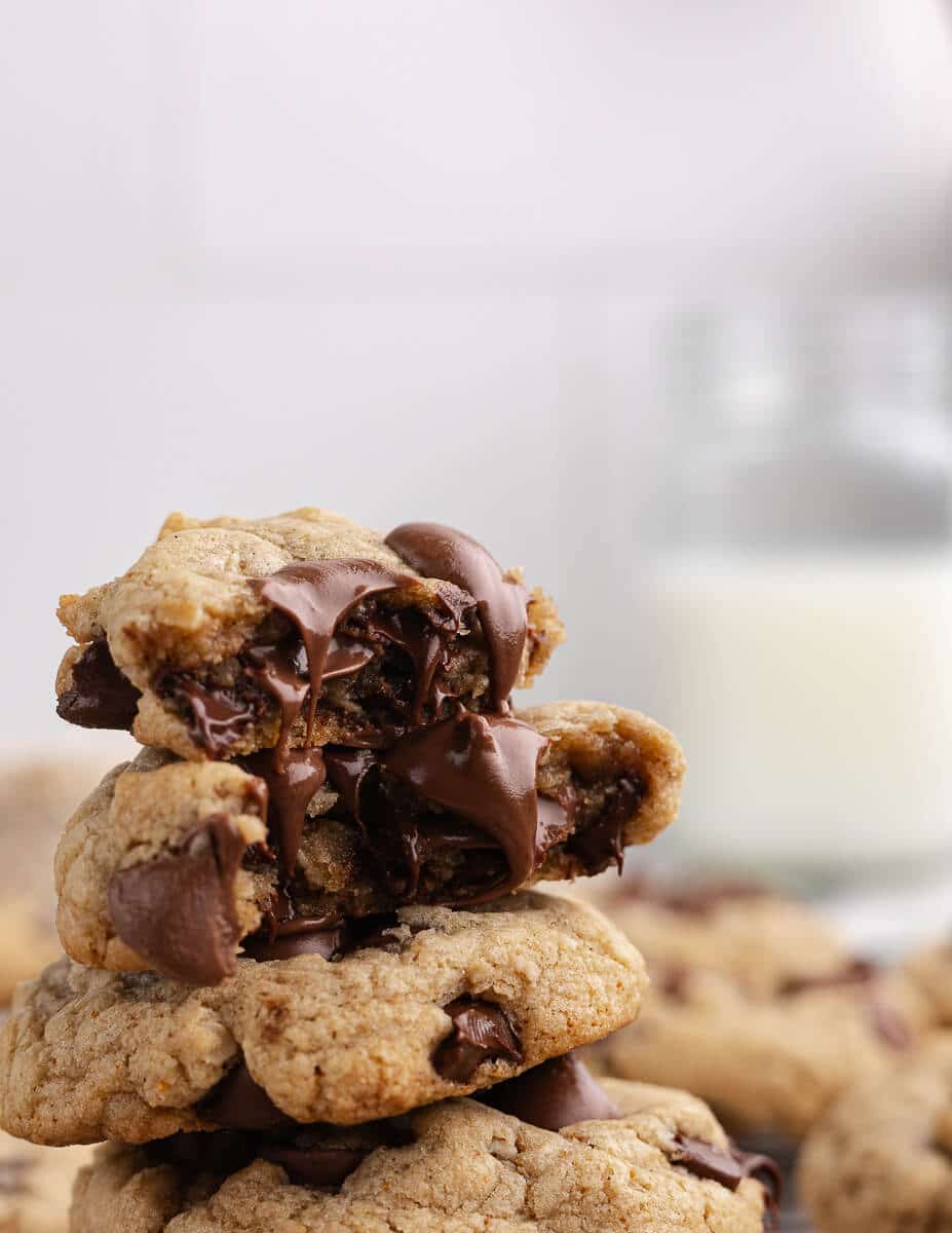 a stack of gluten free chocolate chip cookies with chocolate oozing out.
