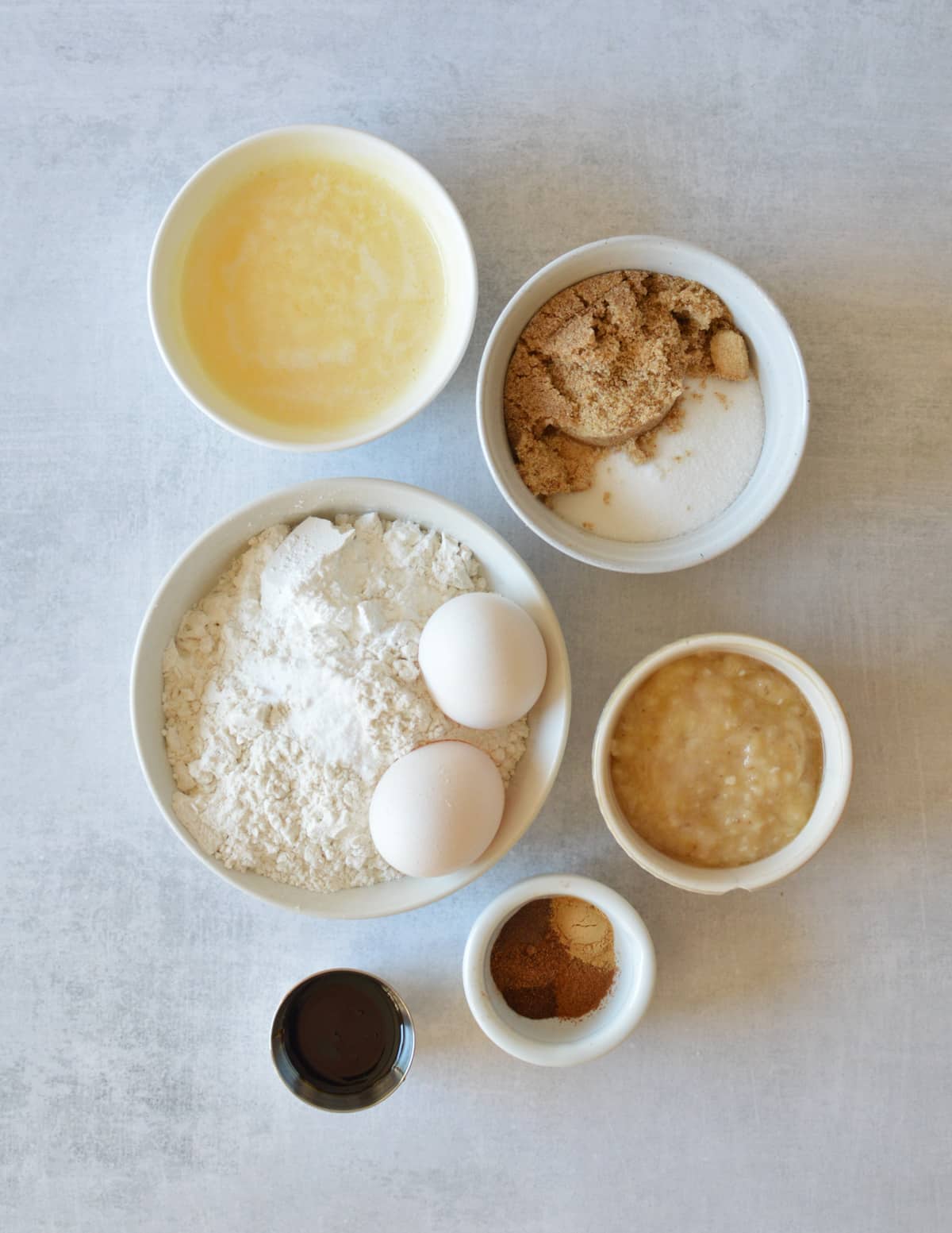 melted butter, sugar, brown sugar, gluten-free flour, baking powder, baking soda, eggs, mashed banana, molasses, and spices.