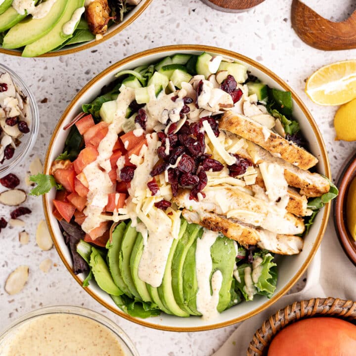 mixed greens salad with avocado, grilled chicken, tomatoes, cheese, dried cranberries, and homemade honey mustard.