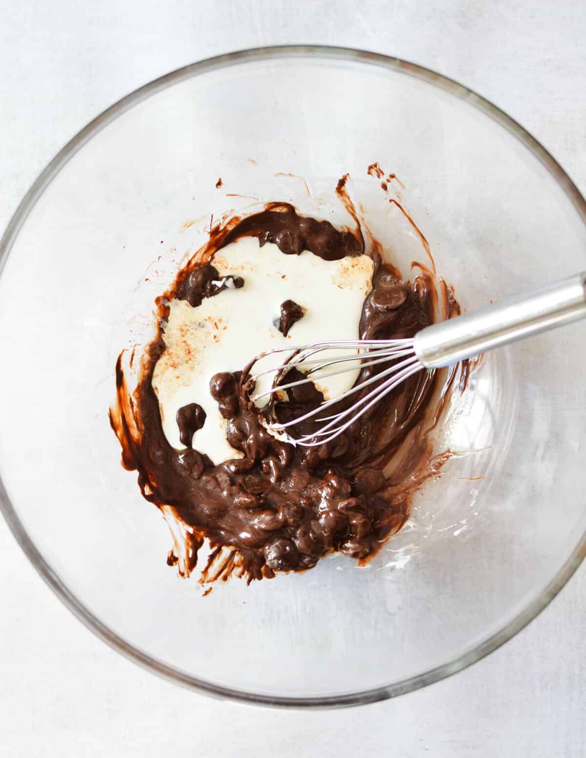 a bowl of melted chocolate and cream.