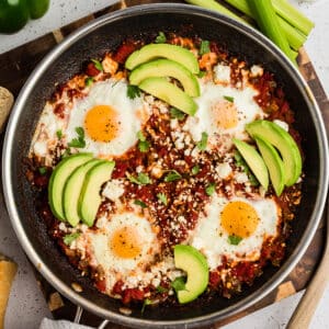 shakshuka with feta and sliced avocado on top