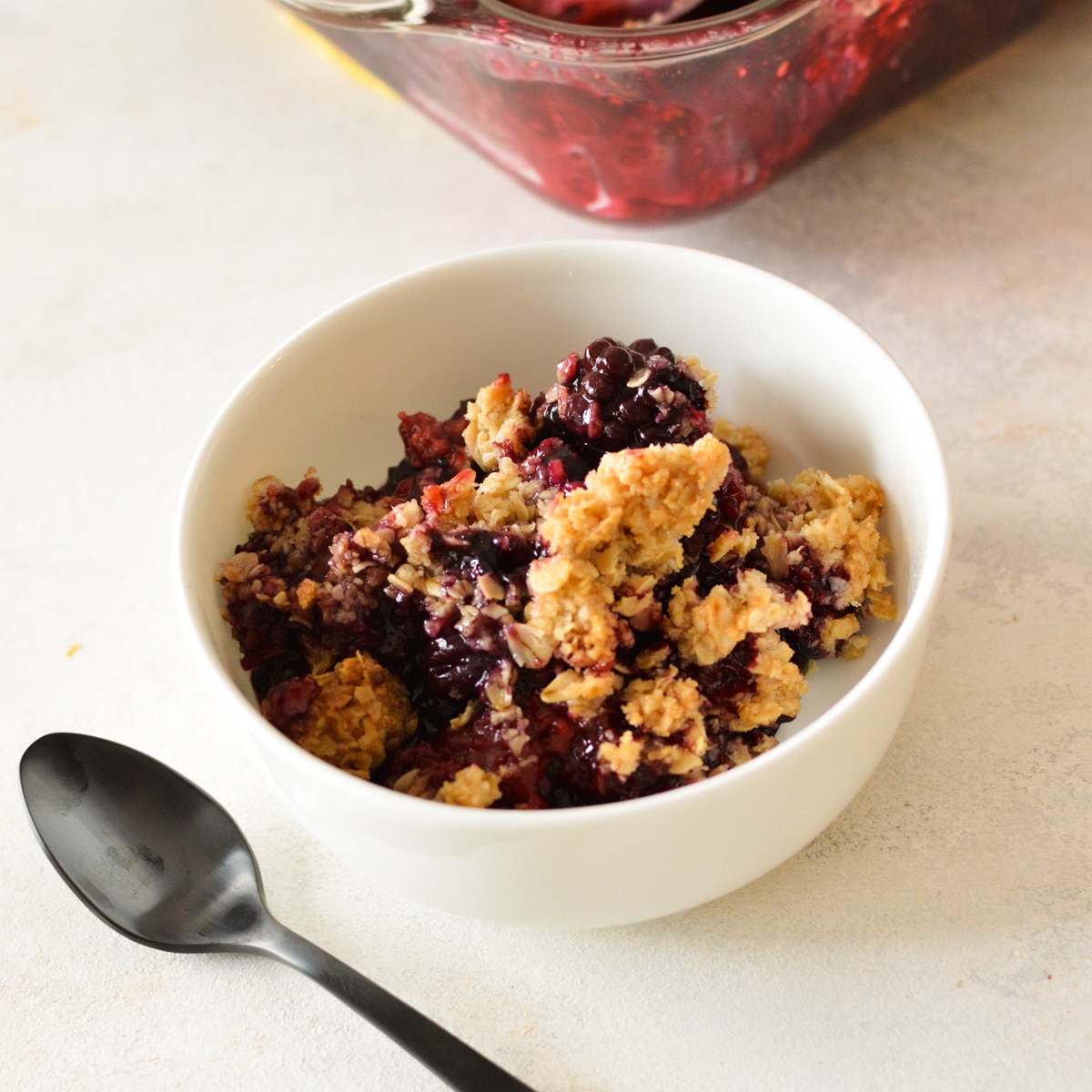 berries with crumb topping in a bowl