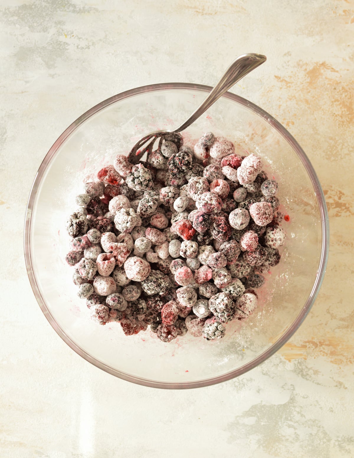 a bowl of mixed berries coated in cornstarch