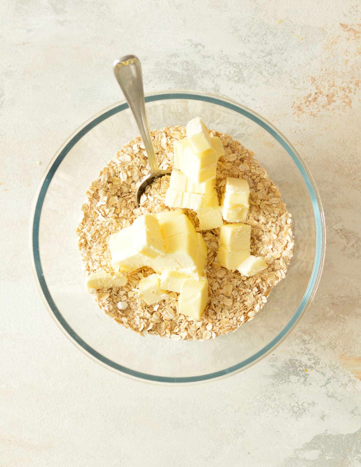 a bowl of oats and sugar with butter on top