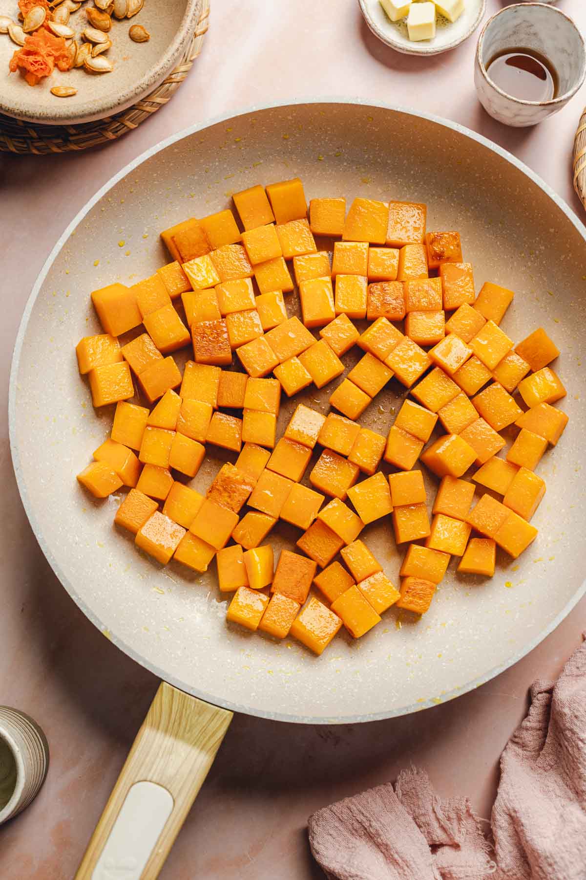 sauteed butternut squash in a skillet.