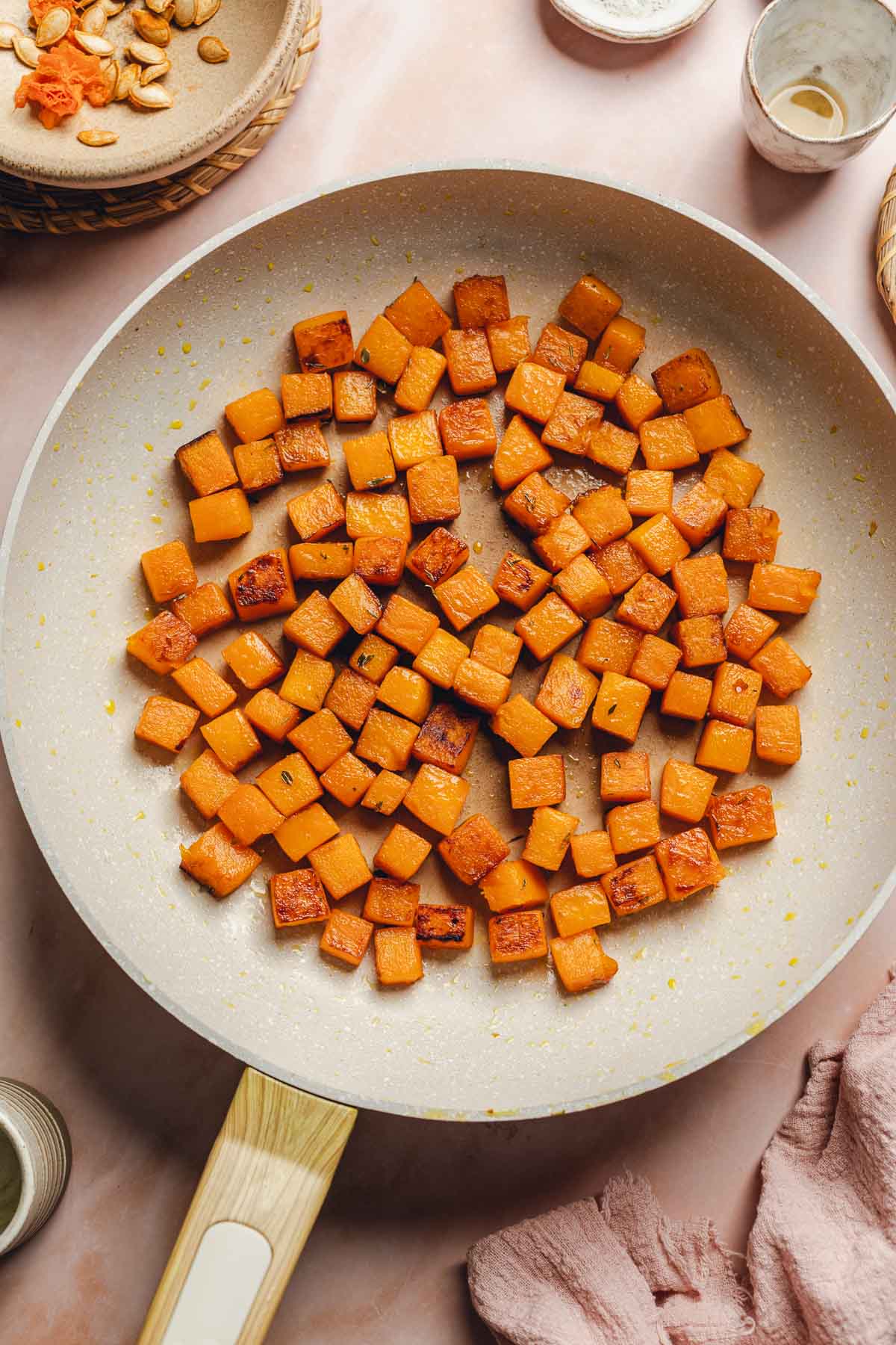 caramelized butternut squash cubes in a skillet.