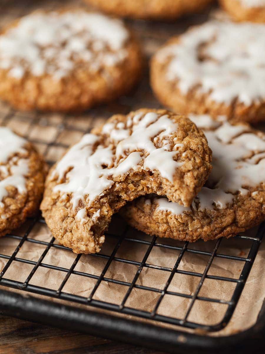 iced oatmeal cookies on a wire rack. 