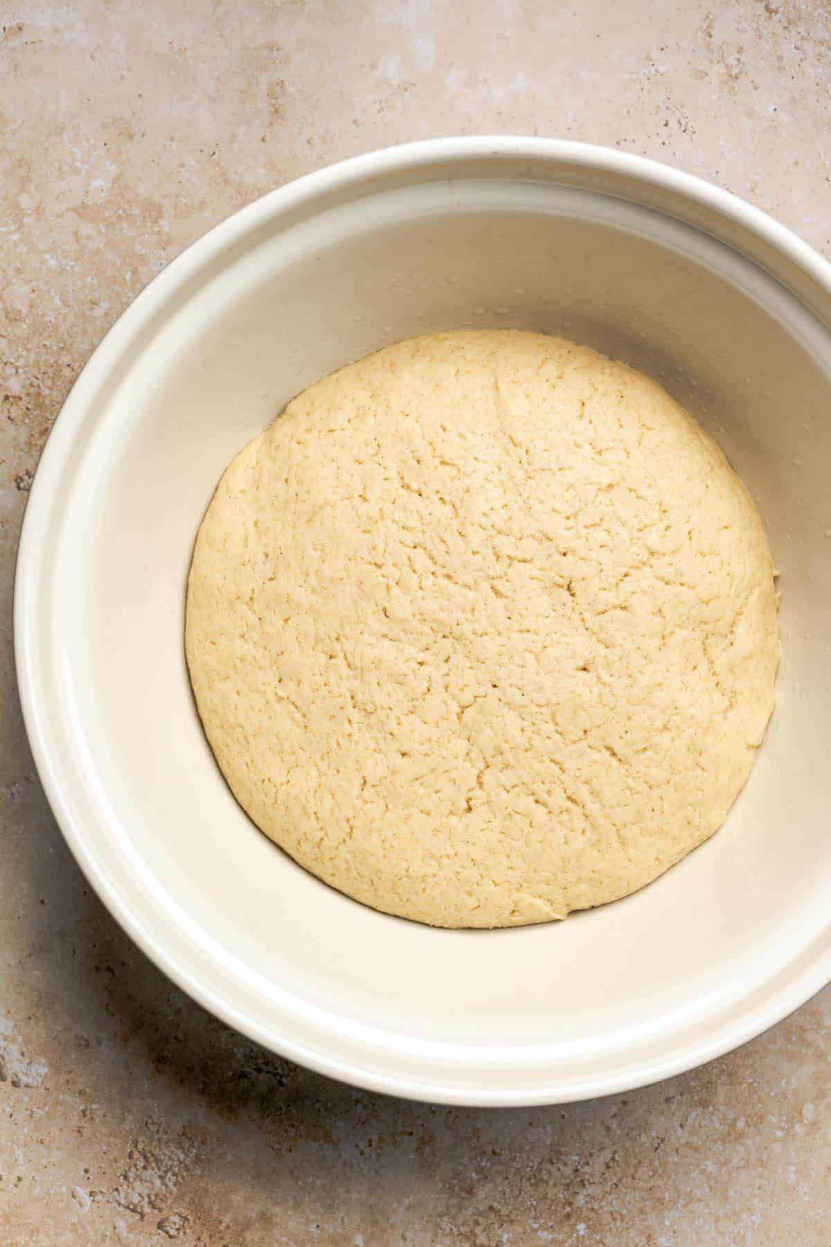 gluten free dough in a bowl that's risen for two hours.