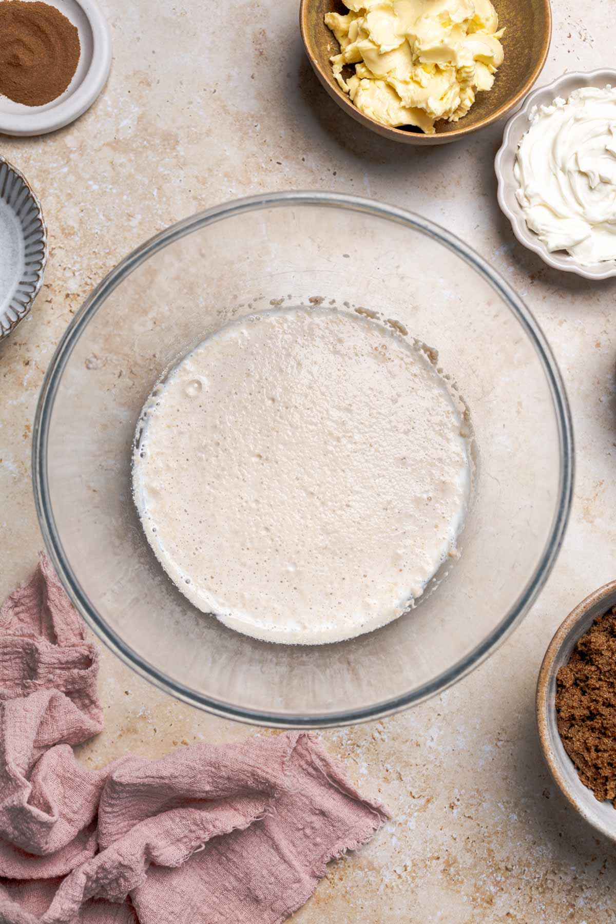 frothy yeast in a bowl with milk.