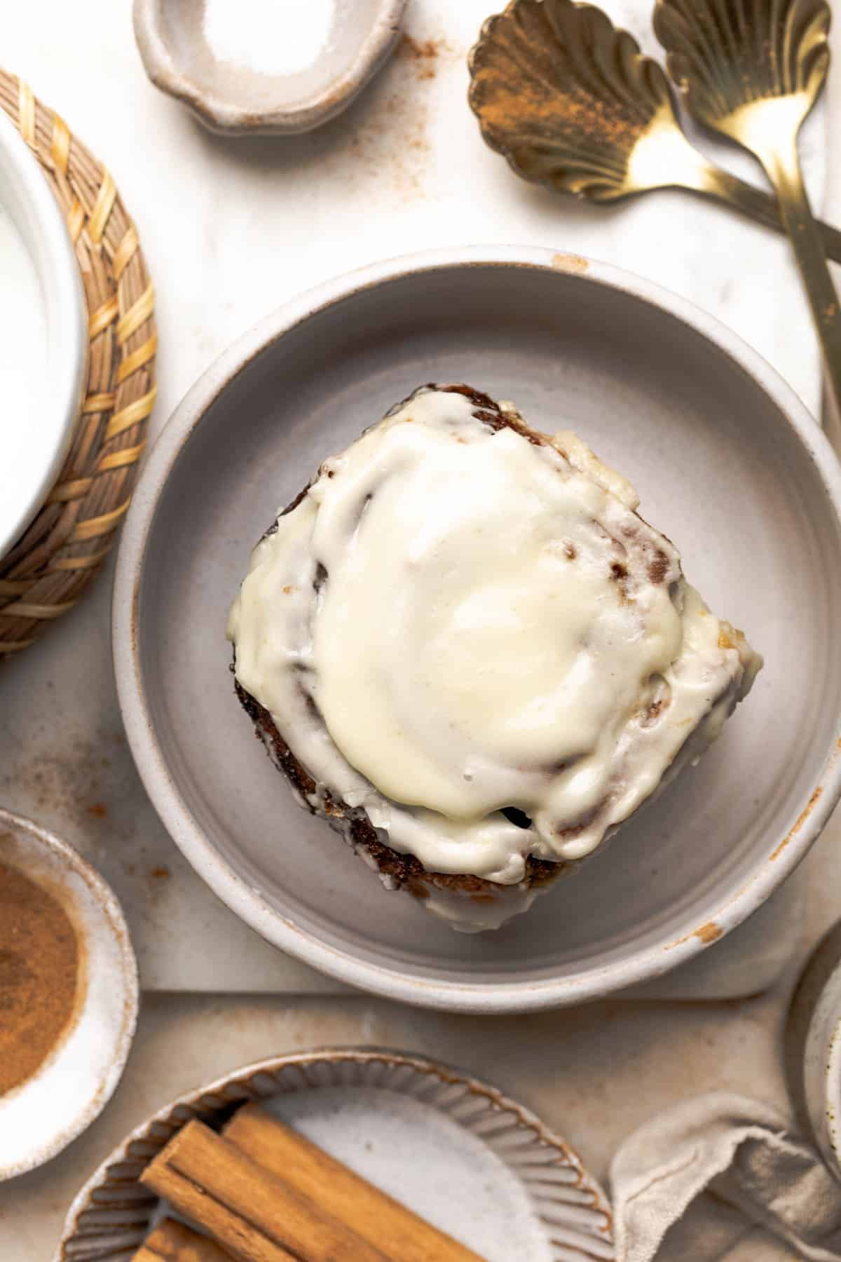 a gluten free cinnamon roll on a plate.