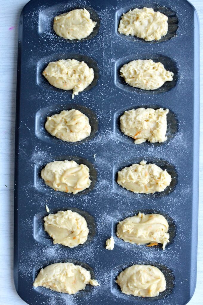 madeleine pan filled with batter in each mold