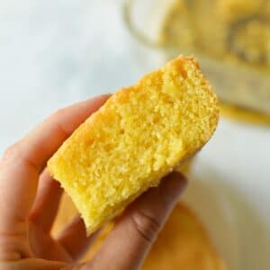 hand holding a slice of cornbread