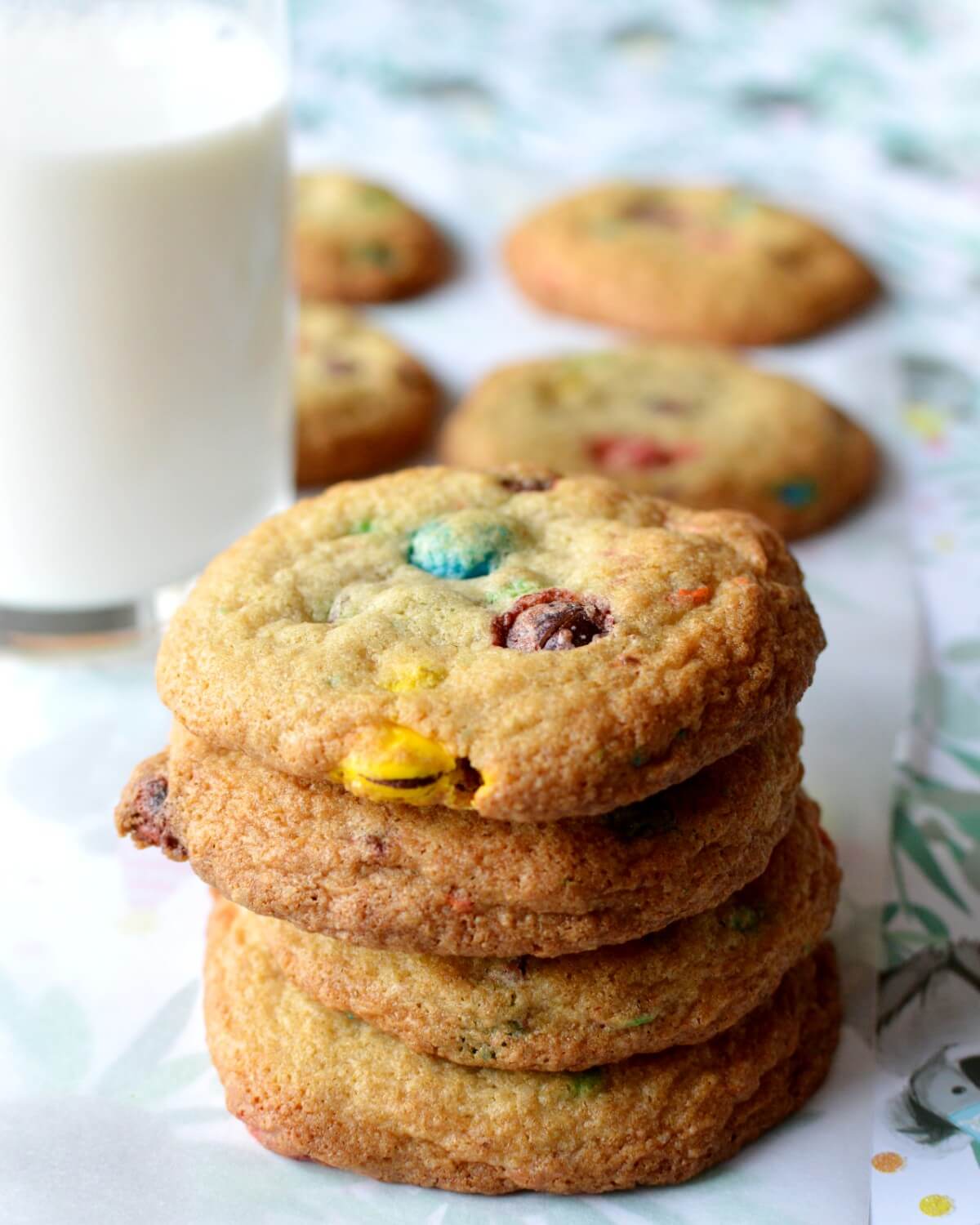 A close up of a stack of m&m cookies.