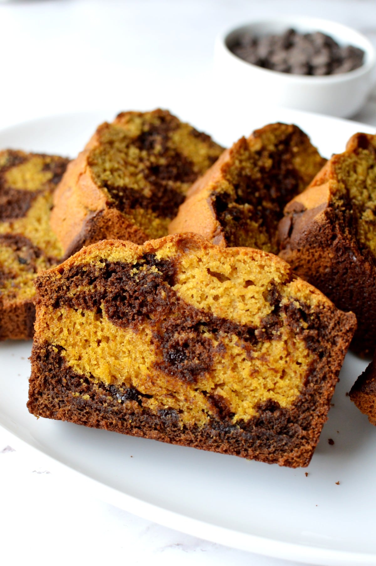 Close up of a piece of marble pumpkin bread