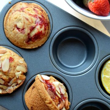 A muffin pan with strawberry muffins