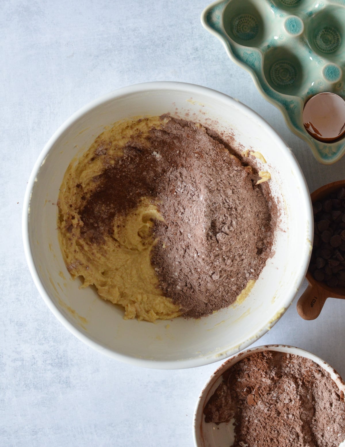 a bowl of creamed butter, sugar, and egg with gluten-free flour on top.
