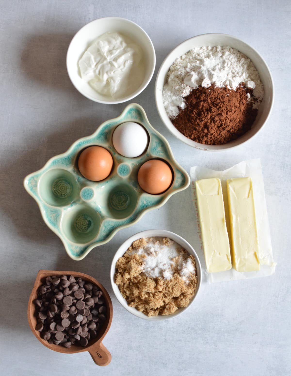 sour cream, gluten-free flour, cocoa powder, eggs, butter, brown sugar, sugar, and chocolate chips.