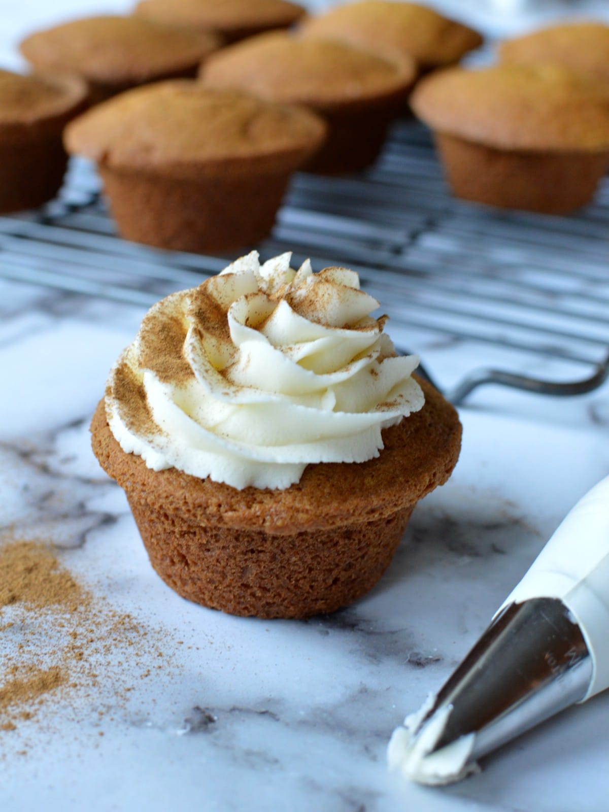 gluten free pumpkin cupcake with cinnamon maple frosting