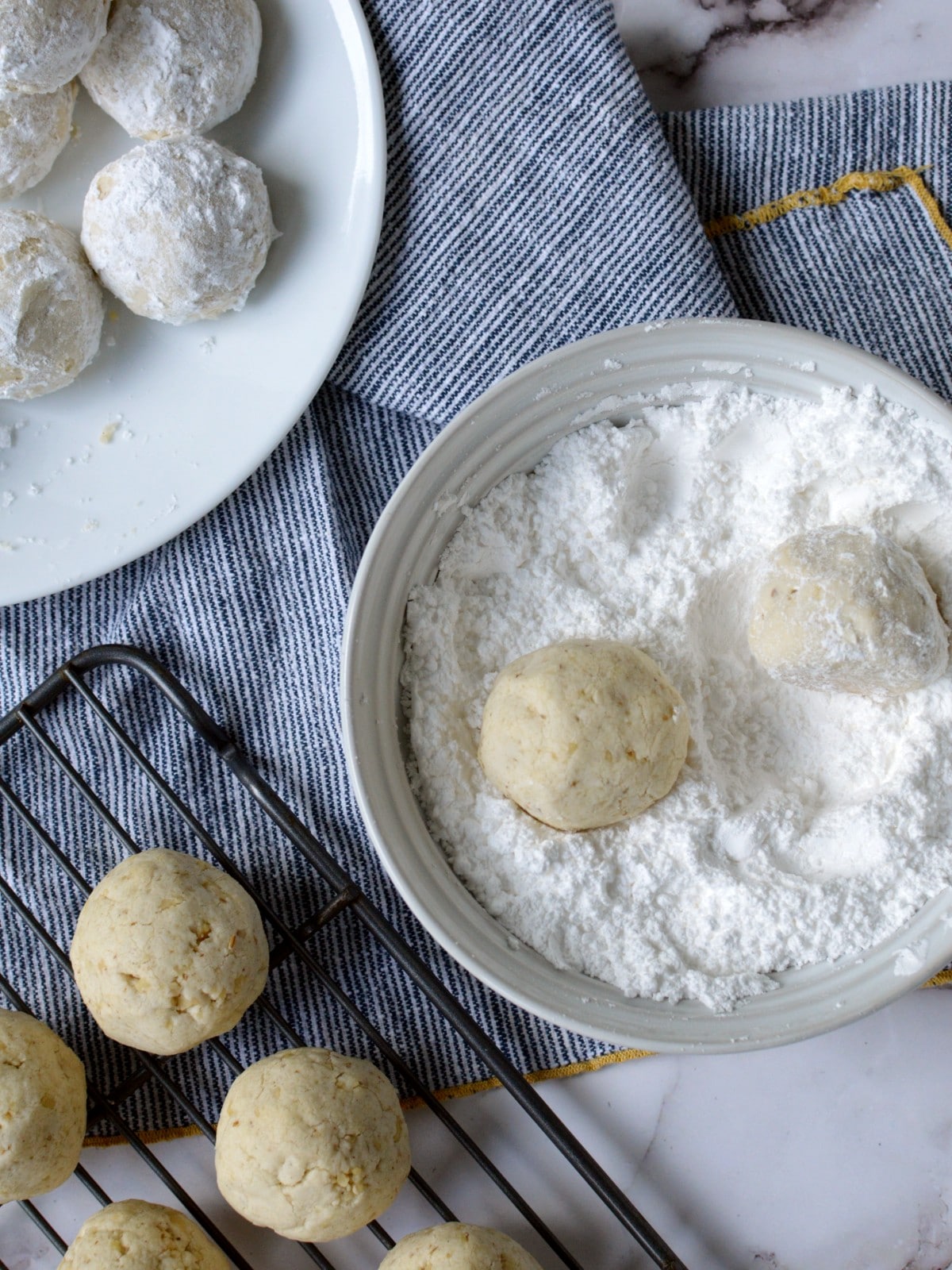 rolling cookies in powdered sugar