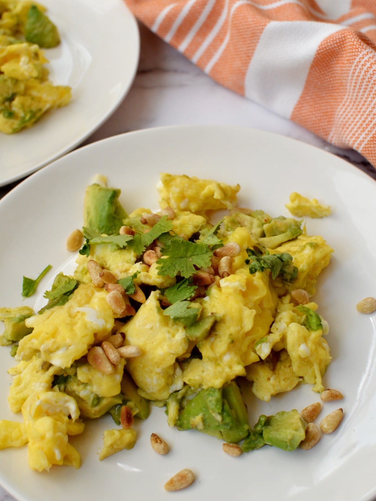 scrambled eggs with avocado and pine nuts