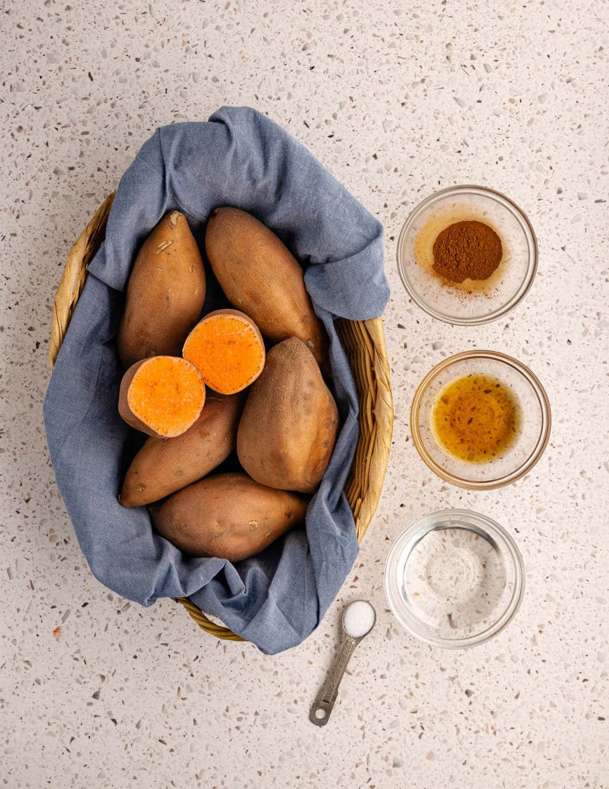 a basked of sweet potatoes, cinnamon, maple syrup, coconut oil, kosher salt.