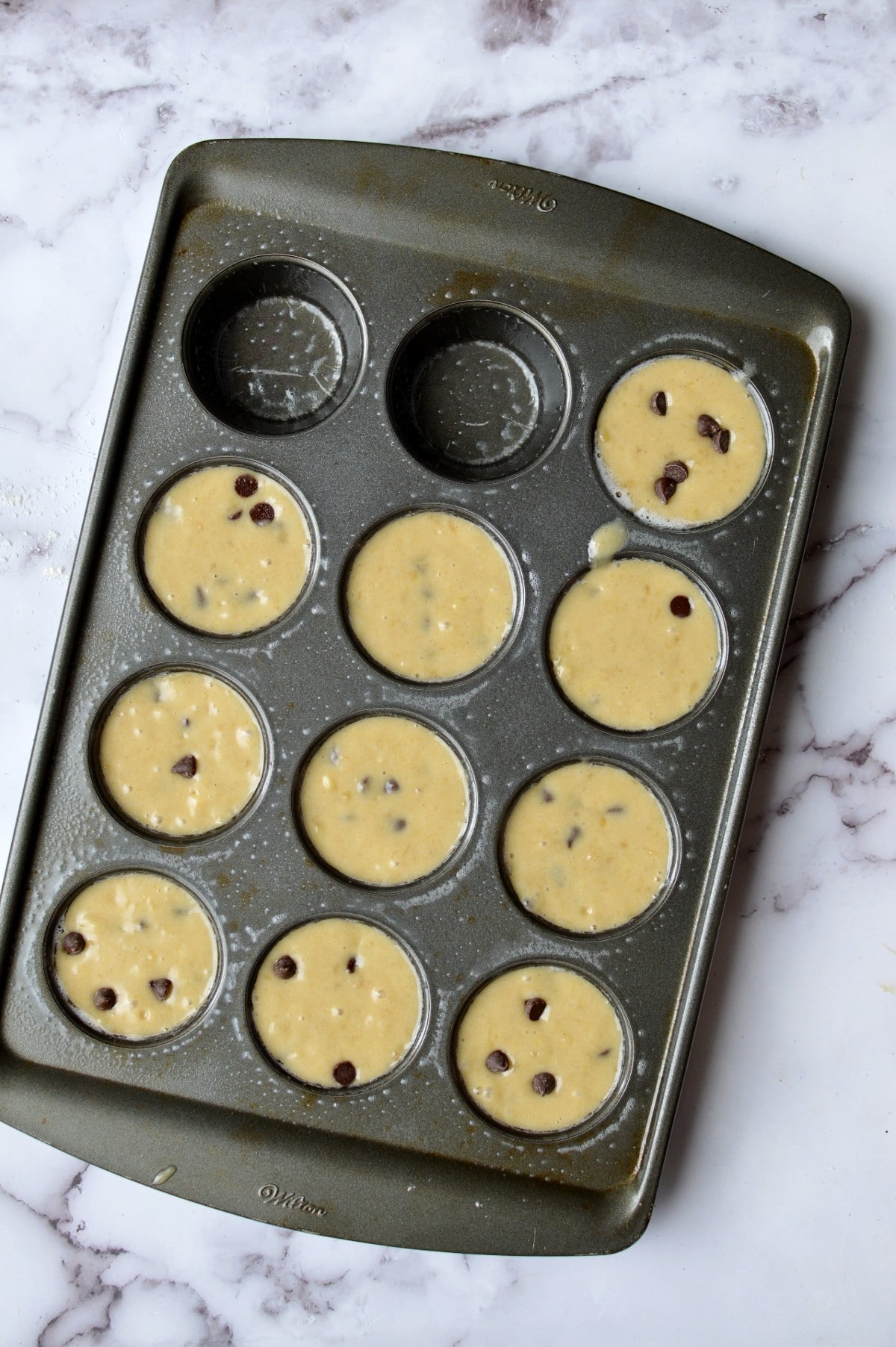 a muffin tin filled with batter