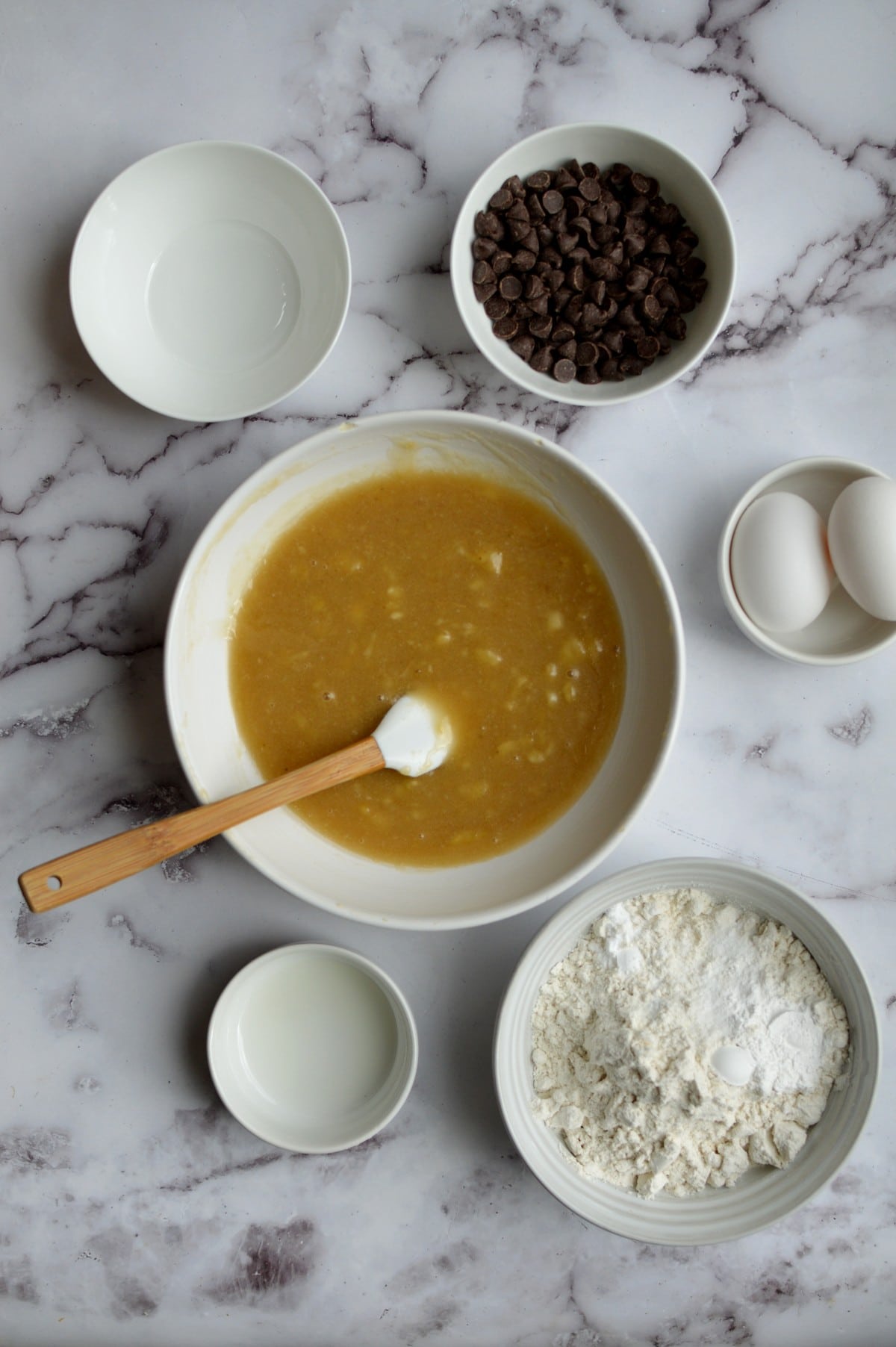 sugar, oil, and banana mixed together in a bowl