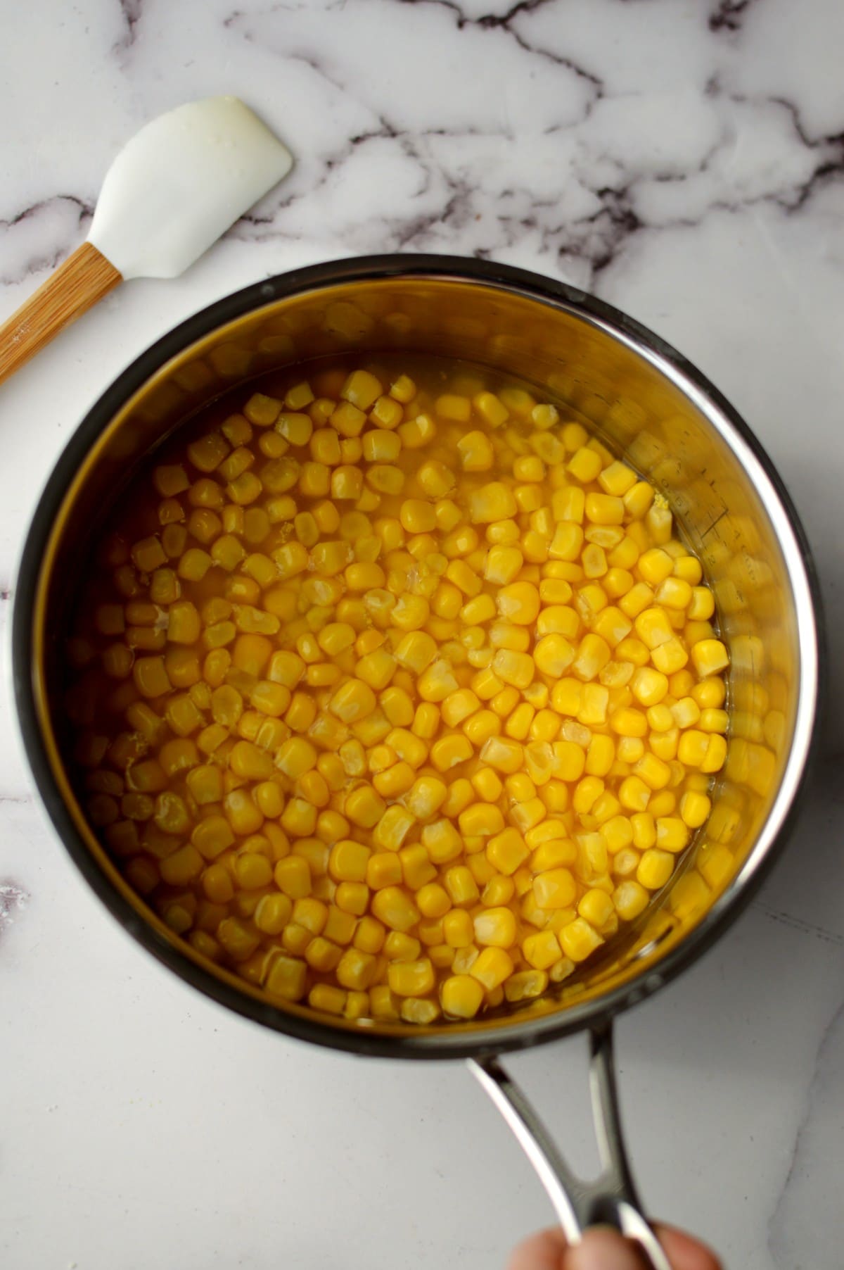 a can of corn in a pot