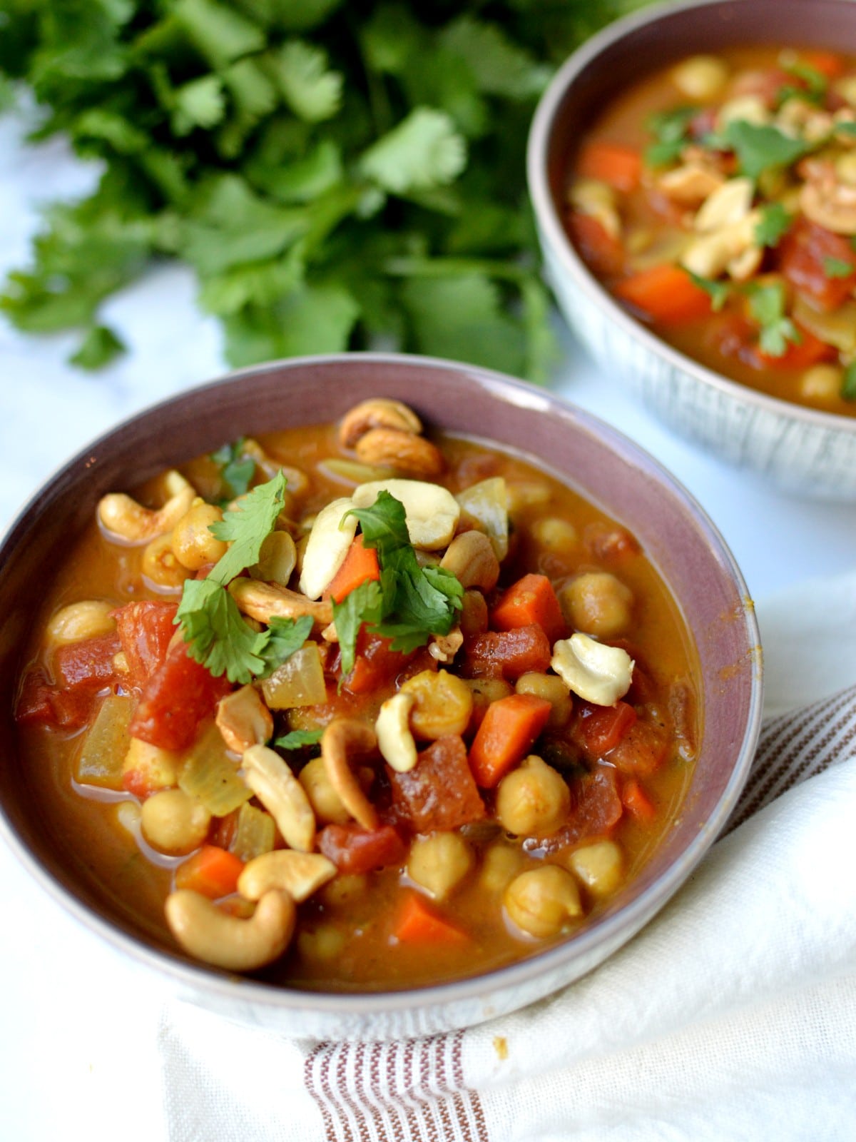 a bowl of vegan chickpea curry with cashews