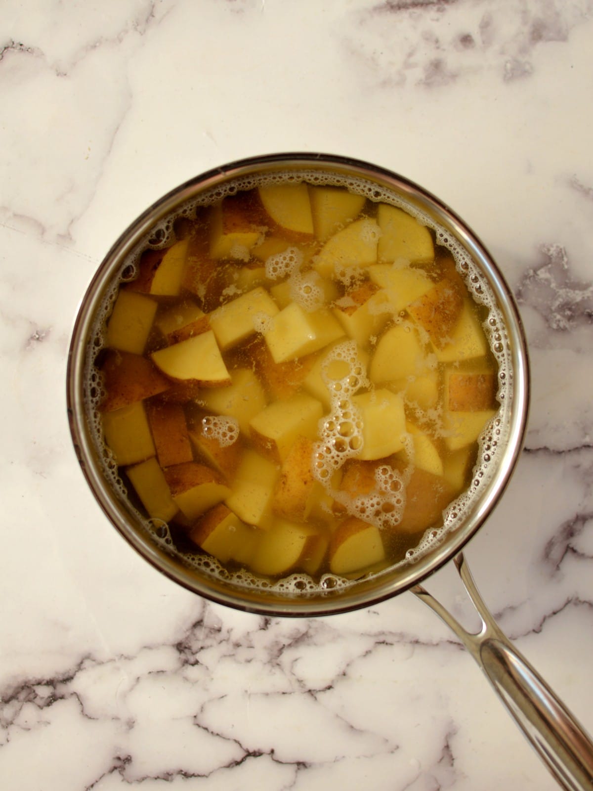 cut up potatoes in a pot with water