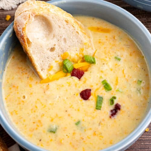 a bowl of potato soup with a slice of bread in it.