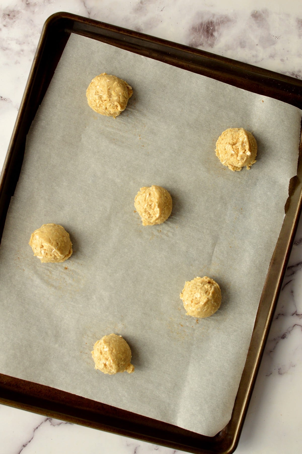 cookie dough scoops on a sheet pan