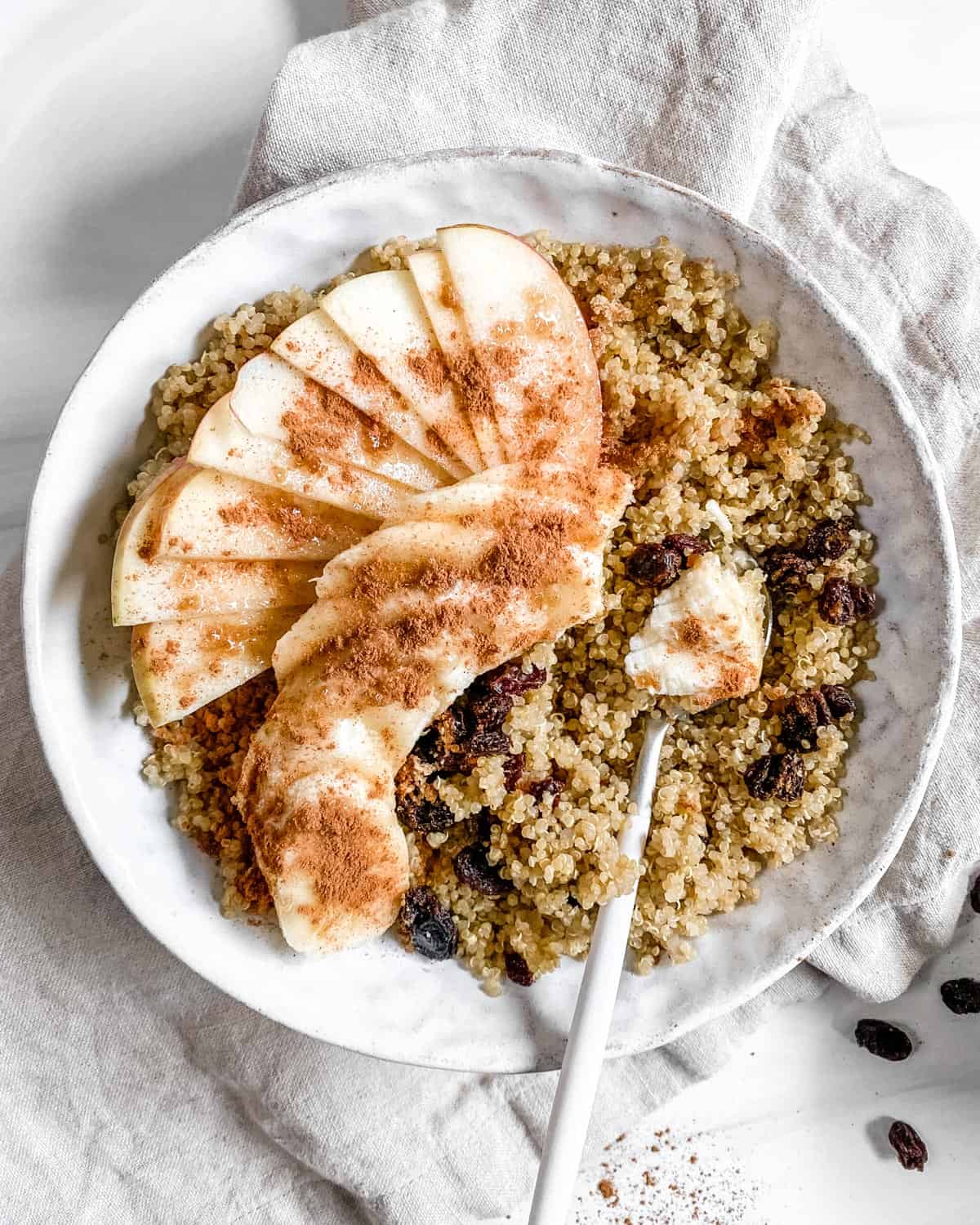 a bowl of quinoa with apples and cinnamon