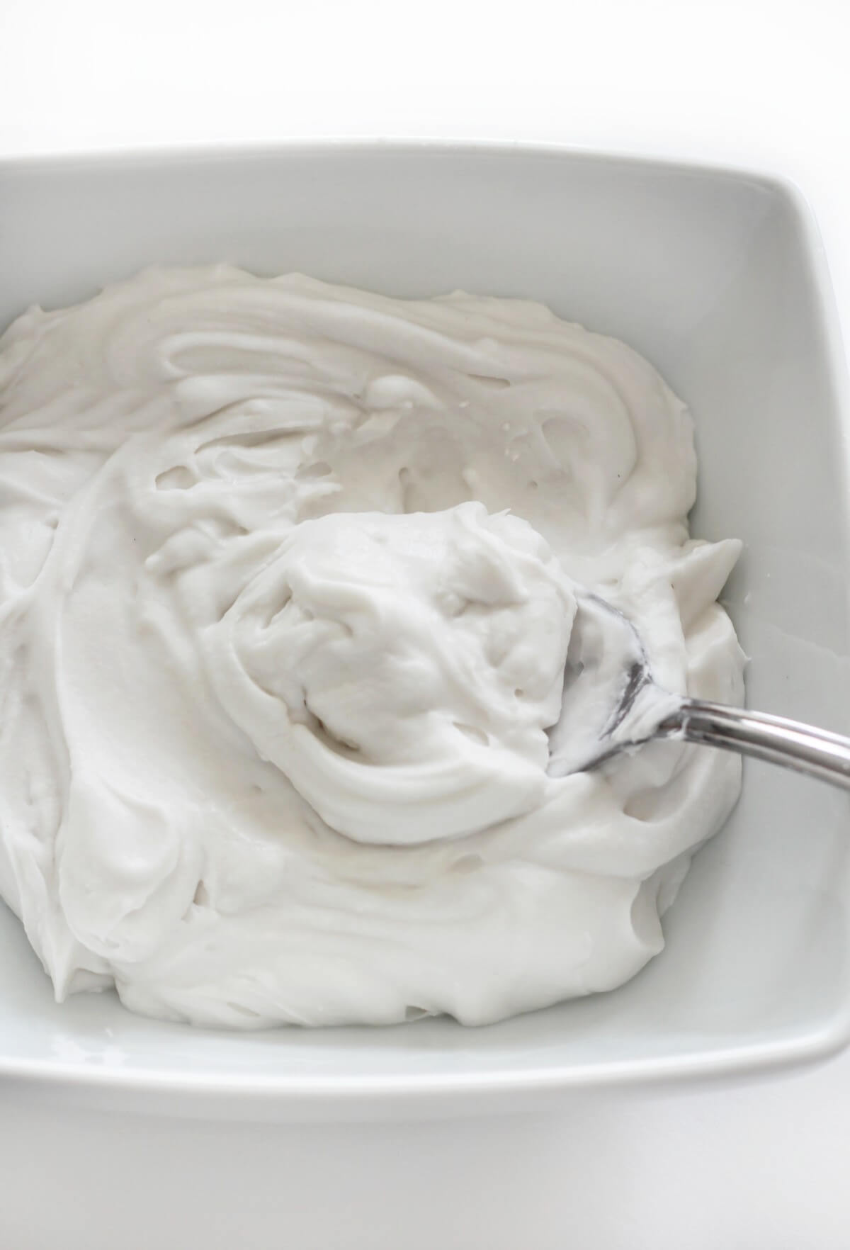 a bowl of coconut whipped cream