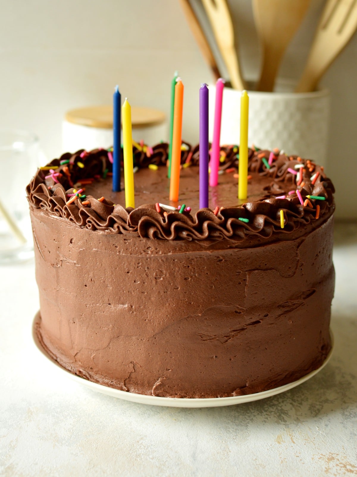 a gluten-free dairy-free cake with chocolate buttercream and sprinkles