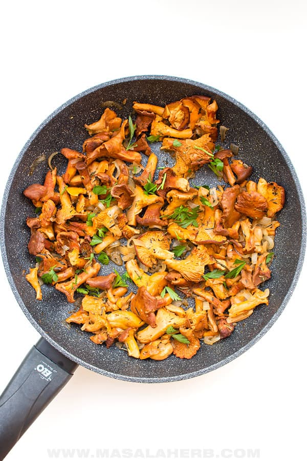 a saute pan with chanterelle mushrooms in it