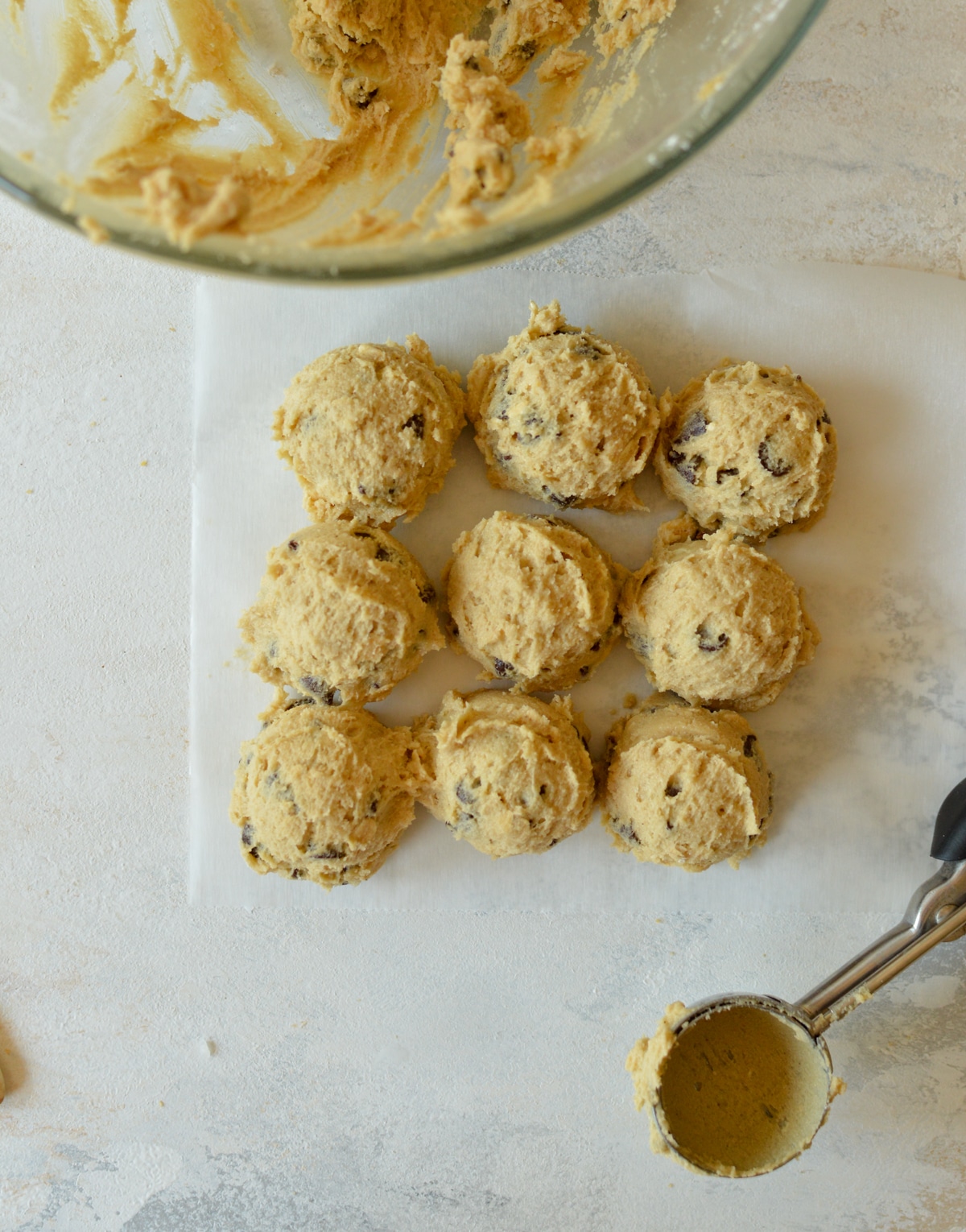 cookie dough balls on parchment paper