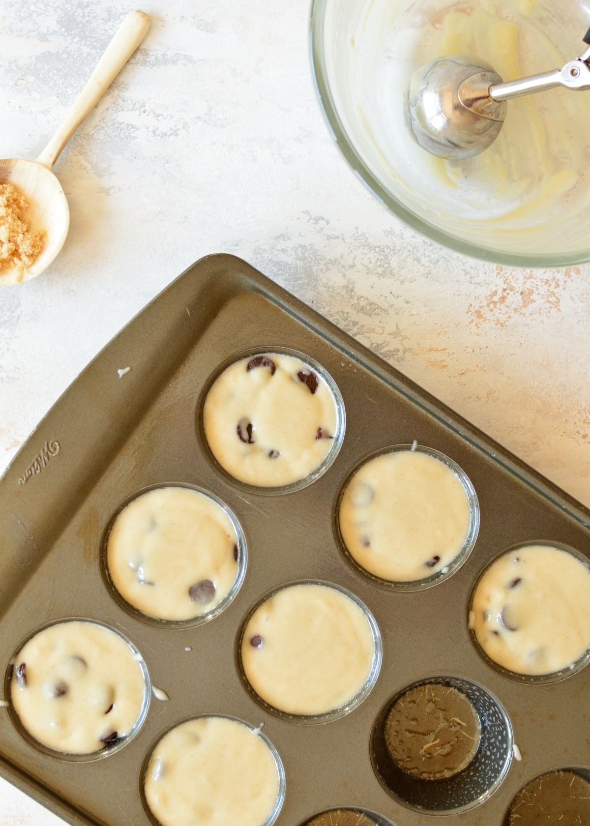 gluten free muffin batter in a muffin tin