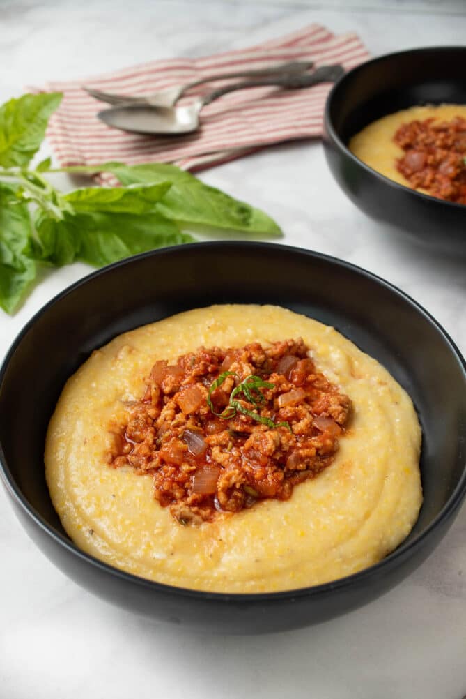 a bowl of polenta with sausage