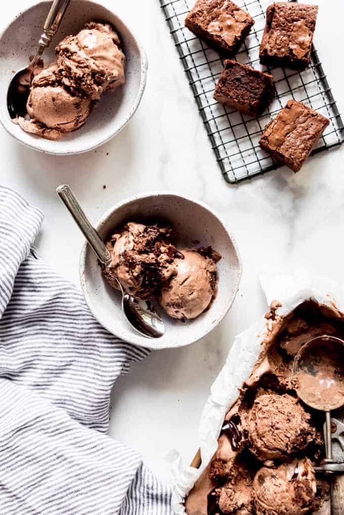 two bowls of chocolate ice cream next to brownies