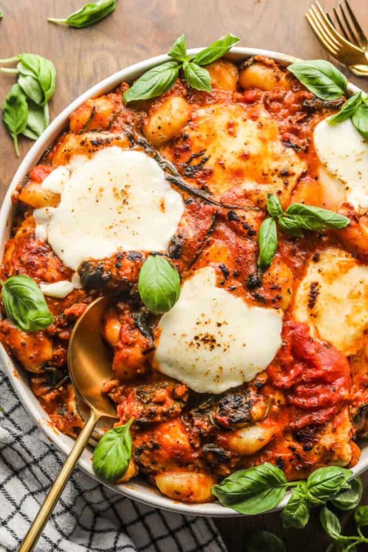 a plate of sausage and gnocchi in sauce