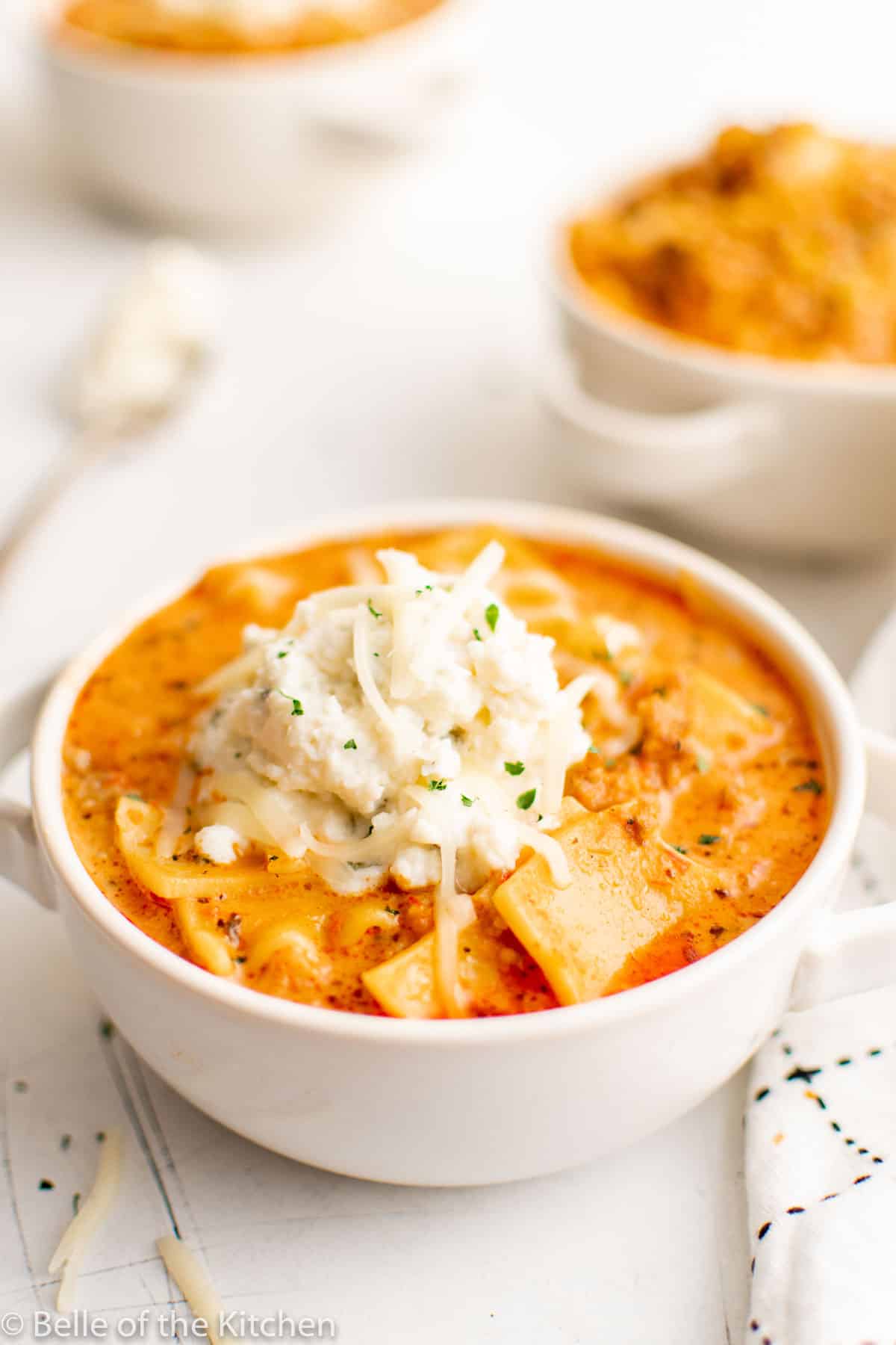 a bowl of lasagna soup with ricotta