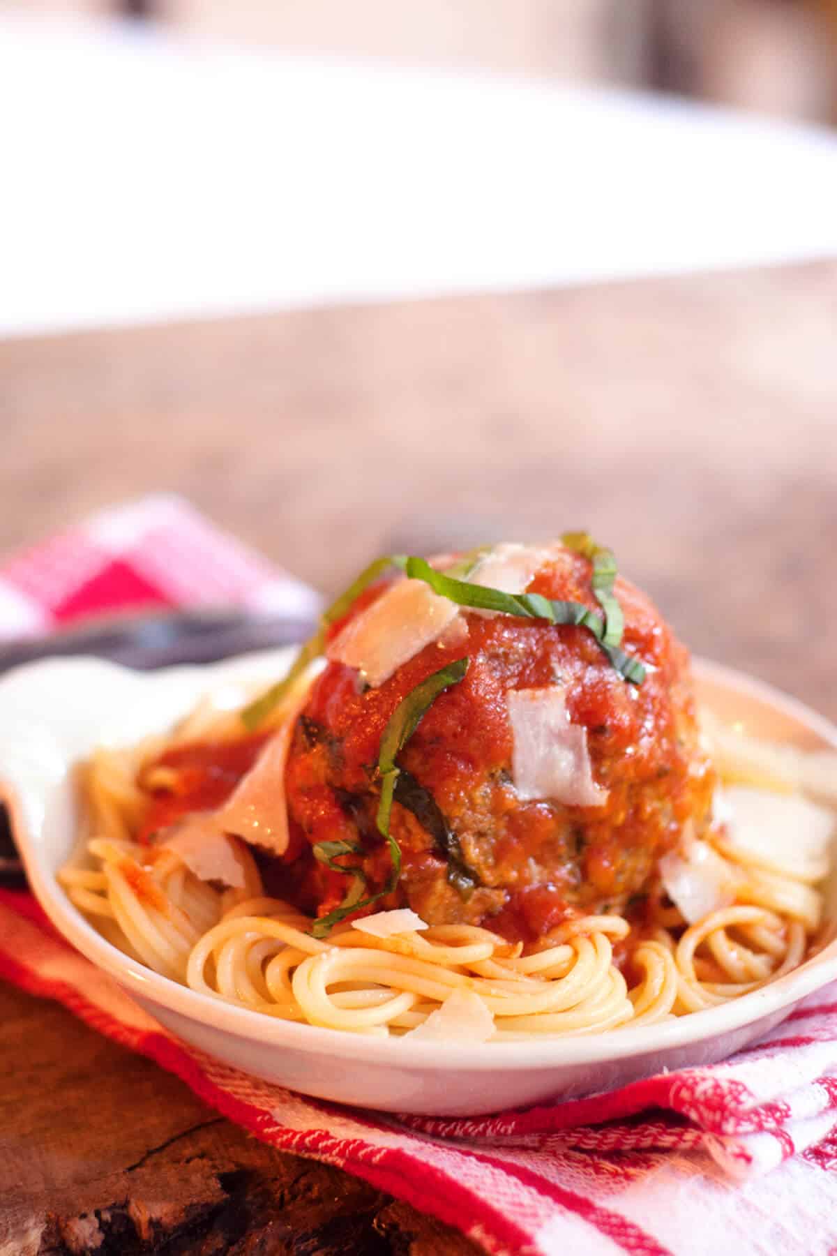 a jumbo meatball on spaghetti